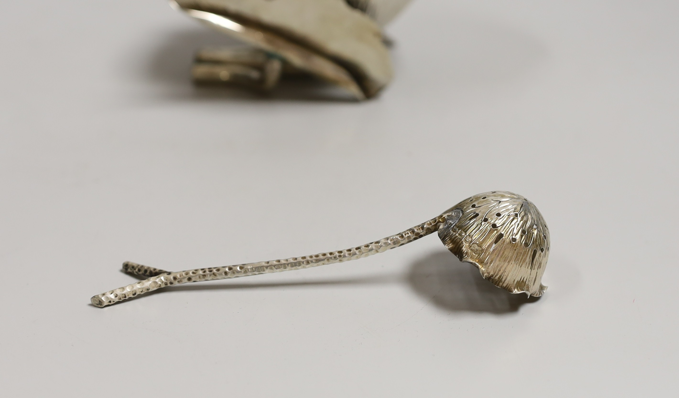 An Edwardian silver lotus shaped sugar bowl and matching sugar sifting spoon, by Hukin & Heath, London, 1902, bowl diameter 11.8cm, 7.5oz.